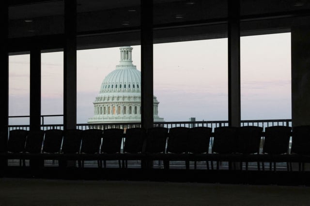 Dawn brightens the sky over the U.S. Capitol dome, seen from an empty meeting room during the continuing partial federal government shutdown in the Hart Senate Office Building on Capitol Hill in Washington, D.C., U.S., October 7, 2025. REUTERS/Jonathan Ernst
