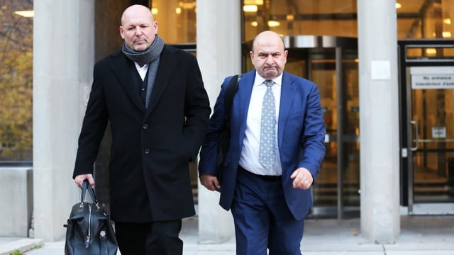 Former St. Michael's Hospital executive Vas Georgiou, right, leaves court with his lawyer Peter Brauti last year. Georgiou was found guilty of two counts of fraud on Tuesday.