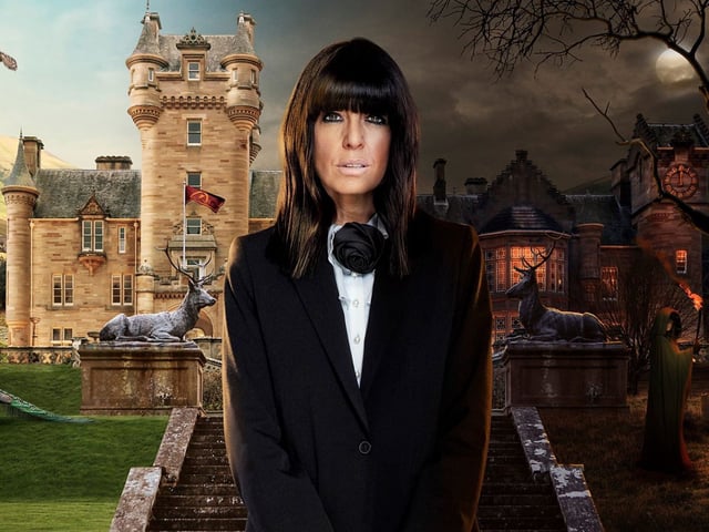 Claudia Winkleman, host of The Traitors U.K., in front of a castle