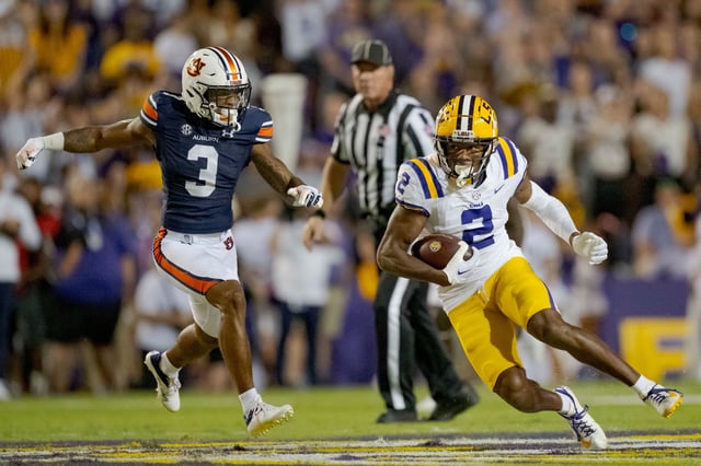 Former LSU wide receiver Lacy runs after a catch against Auburn in October 2023.