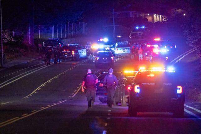 Several police vehicles sit by the intersection of Northeast 148th Avenue and Halsey Street on Saturday, April 19, 2025. Police had stopped the driver of a silver Audi sedan, who fled from officers working a street takeover mission and took them into Vancouver and back into Portland.