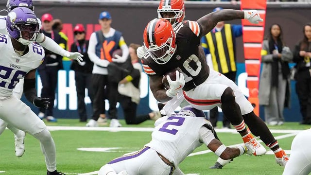 Oct 5, 2025; Tottenham, United Kingdom; Cleveland Browns running back Quinshon Judkins (10) gets tripped up against Minnesota Vikings cornerback Isaiah Rodgers (2) during the third quarter of an NFL International Series game at Tottenham Hotspur Stadium. Mandatory Credit: Kirby Lee-Imagn Images