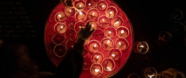 This picture taken on November 11, 2024 shows participants preparing lanterns to attach to hot-air balloons with fireworks on the opening day of the week-long Tazaungdaing Lighting Festival in Taunggyi, Myanmar's northeastern Shan State. (Photo by Sai Aung MAIN / AFP) (Photo by SAI AUNG MAIN/AFP via Getty Images)