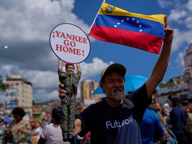 A man holds a doll of late President Hugo Chavez near the United Nations' office in Caracas, Venezuela, during a government-organized rally against foreign interference on Monday, Oct. 6, 2025. (AP Photo/Ariana Cubillos)