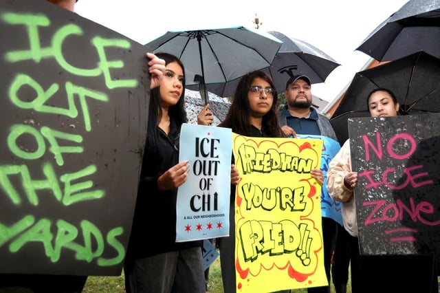 Standing in the rain near a reported Immigration and Customs Enforcement staging area, dozens of activists, elected officials and supporters hold, protest the ICE presence on the Southwest Side, at a news conference, in the Back of the Yards neighborhood in Chicago, Oct. 7, 2025.  (Antonio Perez/Chicago Tribune)
