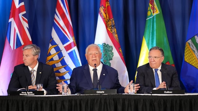 Ontario Premier Doug Ford, centre, speaks as Nova Scotia Premier Tim Houston, left, and Quebec Premier François Legault listen during the 2025 summer meetings of Canada’s Premiers at Deerhurst Resort in Huntsville, Ont. The three premiers, along with Alberta Premier Danielle Smith and Saskatchewan Premier Scott Moe, signed a letter calling on the federal government to pull its legal submission for limits on the notwithstanding clause.