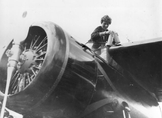 American aviator Amelia Earhart (1898 - 1937) in the cockpit of her aeroplane at Culmore, near Derry, Ireland, after her solo Atlantic flight. (Photo by Topical Press Agency/Getty Images)
