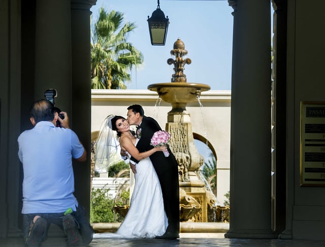 PASADENA, CA – October 15: A wedding photographer photographs pre wedding photos of Helen Wynn Nguyen of Westminister and David Bui of Gardena at Pasadena City Hall Wednesday, October 15, 2014. (Photo by Walt Mancini/Pasadena Star-News