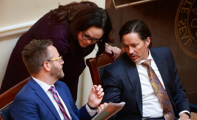 Sen. Brady Brammer, sponsor of SB1011 Redistricting Standards, Senate Minority Leader Luz Escamilla and Sen. Kirk Cullimore, R-Draper, look at potential redistricting maps as SB1012 Congressional Boundaries Designation is debated in the Senate chamber during a special session at the Capitol in Salt Lake City on Monday, Oct. 6, 2025.