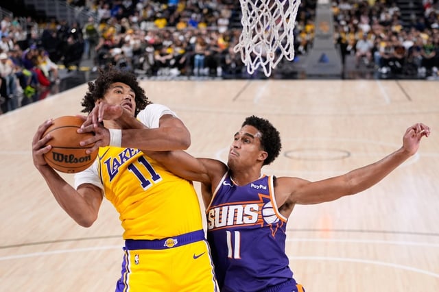 Lakers center Jaxson Hayes, left, grabs a rebound away from Phoenix Suns center Oso Ighodaro during the second half of a preseason game on Friday night in Palm Desert. (AP Photo/Mark J. Terrill)