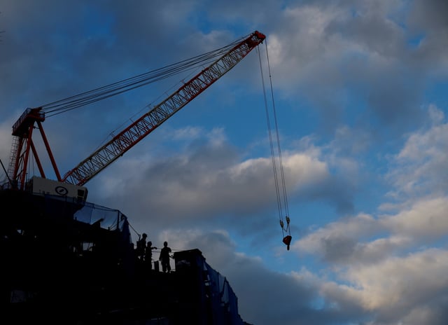 Workers are seen at a construction site at a business district in Tokyo, Japan January 23, 2024. REUTERS/Kim Kyung-Hoon