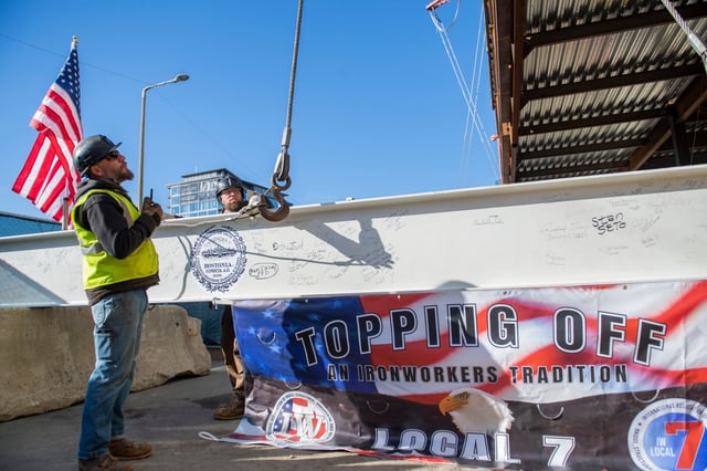 Schools in Gateway Cities and Boston have received disproportionately low state funding for building, according to a new MassINC report. In this 2022 photo, construction workers prepare a beam during a topping ceremony at the Josiah Quincy Upper School. (Staff Photo By Stuart Cahill/Boston Herald, File)