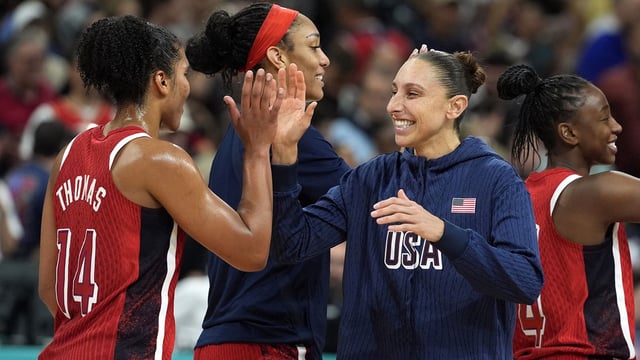 Aug 4, 2024; Villeneuve-d'Ascq, France; United States power forward Alyssa Thomas (14) and shooting guard Diana Taurasi (12) celebrate after defeating Germany in a women’s group C game during the Paris 2024 Olympic Summer Games at Stade Pierre-Mauroy. Mandatory Credit: John David Mercer-Imagn Images