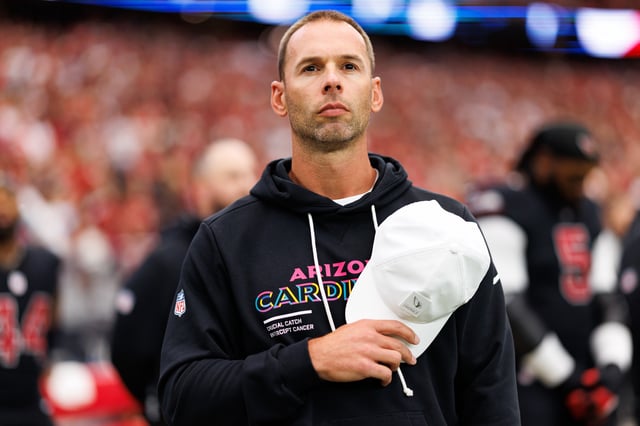 Head coach Jonathan Gannon of the Arizona Cardinals stands on the sidelines during the national anthem prior to an NFL football game against the Tennessee Titans at State Farm Stadium on October 05, 2025 in Glendale, Arizona. (Photo by Brooke Sutton/Getty Images)