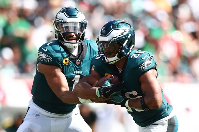 TAMPA, FLORIDA - SEPTEMBER 28: Jalen Hurts #1 of the Philadelphia Eagles hands off the ball to Saquon Barkley #26 during the second half of the game against the Tampa Bay Buccaneers at Raymond James Stadium on September 28, 2025 in Tampa, Florida. (Photo by Megan Briggs/Getty Images)