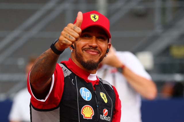 SINGAPORE, SINGAPORE - OCTOBER 05: Lewis Hamilton of Great Britain and Scuderia Ferrari gives a thumbs up on the drivers parade prior to the F1 Grand Prix of Singapore at Marina Bay Street Circuit on October 05, 2025 in Singapore, Singapore. (Photo by Bryn Lennon/Getty Images)