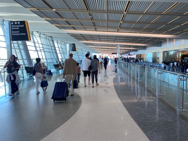 Travelers walk with luggage in the San Diego International Airport. July 3, 2022.