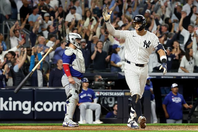 NEW YORK, NEW YORK - OCTOBER 07: Aaron Judge #99 of the New York Yankees celebrates hitting a three-run home run against the Toronto Blue Jays during the fourth inning in game three of the American League Division Series at Yankee Stadium on October 07, 2025 in the Bronx borough of New York City. (Photo by Al Bello/Getty Images)
