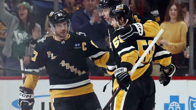 Mar 28, 2024; Pittsburgh, Pennsylvania, USA; Pittsburgh Penguins center Sidney Crosby (87) and defenseman Kris Letang (58) congratulate center Evgeni Malkin (middle) on his power play goal against the Columbus Blue Jackets during the second period at PPG Paints Arena. The Penguins won 3-2. Mandatory Credit: Charles LeClaire-Imagn Images
