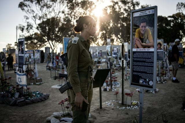 Une militaire israélienne se recueille au mémorial des victimes du 7 octobre 2023 sur le terrain du festival Nova à Reim, dans le sud d'Israël, à l'occasion du deuxième anniversaire des attentats, le 7 octobre 2025