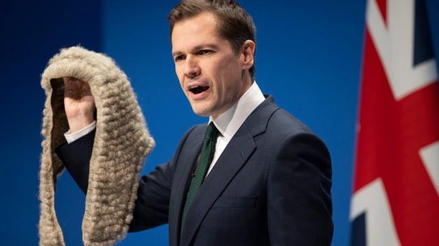 Robert Jenrick brought a wig prop for his speech in Manchester as he hit out at “activist” judges