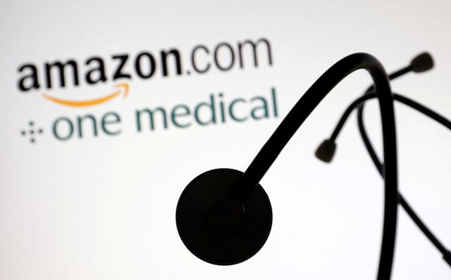 A stethoscope is placed on displayed Amazon.com and One Medical logos in this illustration taken July 26, 2022. REUTERS/Dado Ruvic/Illustration/File Photo