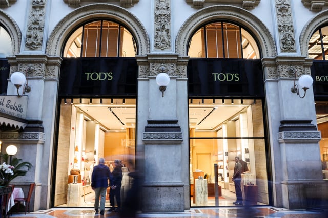 People walk past a Tod's store in Galleria Vittorio Emanuele II, in Milan, Italy, September 27, 2025. REUTERS/Yara Nardi