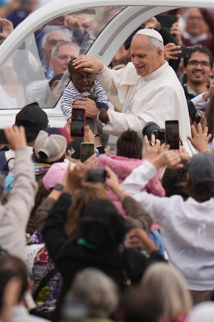 FILE - Pope Leo XIV blesses a child at the end of a Mass for the Jubilee of Migrants and Missionaries in St. Peter's Square at the Vatican, Sunday, Oct. 5, 2025. (AP Photo/Alessandra Tarantino, File)