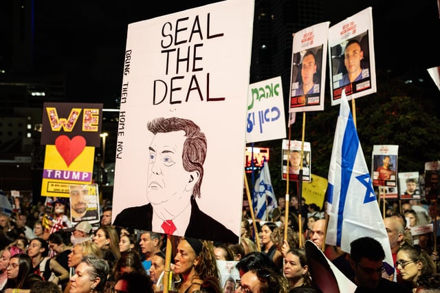 TEL AVIV, ISRAEL - OCTOBER 04: People chant slogans and hold placards in support of hostages still held by Hamas during a solidarity protest, calling for an end to the war and the release of all remaining Israeli hostages on October 04, 2025 in Tel Aviv, Israel. This week, Hamas said it would partly accede to a peace deal brokered by the U.S. president and release the Israeli hostages held in Gaza since Oct. 7, 2023. However, the Palestinian militant group asked for negotiations on several conditions of the 20-point-plan. The Hostages and Missing Families Forum, which represents loved ones of the Israeli captives, said in a statement that "we are in decisive days for a deal - days that will determine when the living hostages return for rehabilitation and the deceased return for proper burial." (Photo by Chris McGrath/Getty Images)