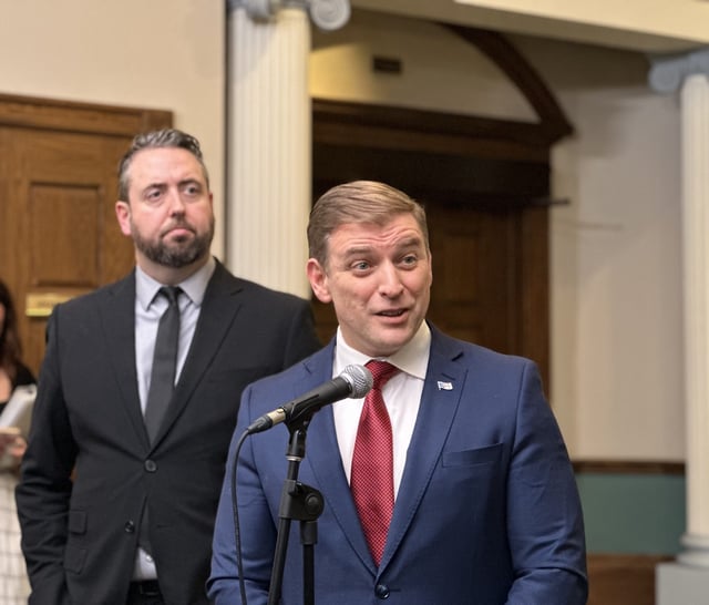  Premier Andrew Furey speaks to reporters at Confederation Building on the second day of the extraordinary sitting to debate the memorandum of understanding signed with Hydro-Quebec. Energy Minister Andrew Parsons stands at left.