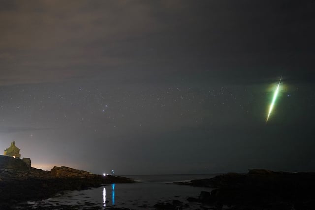 A fisherman watches a meteor during the Draconid meteor shower over Howick rocks in Northumberland. Picture date: Sunday October 10, 2021. (Photo by Owen Humphreys/PA Images via Getty Images)