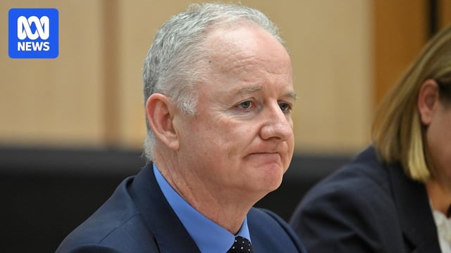 A close up of Hugh Marks grimacing
