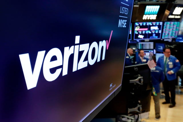 FILE - This April 23, 2018, file photo shows the logo for Verizon above a trading post on the floor of the New York Stock Exchange. (AP Photo/Richard Drew, File)