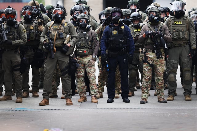 Federal agents, including members of the Department of Homeland Security, the Border Patrol, and police, clash with protesters outside a downtown U.S. Immigration and Customs Enforcement (ICE) facility on October 04, 2025 in Portland, Oregon.