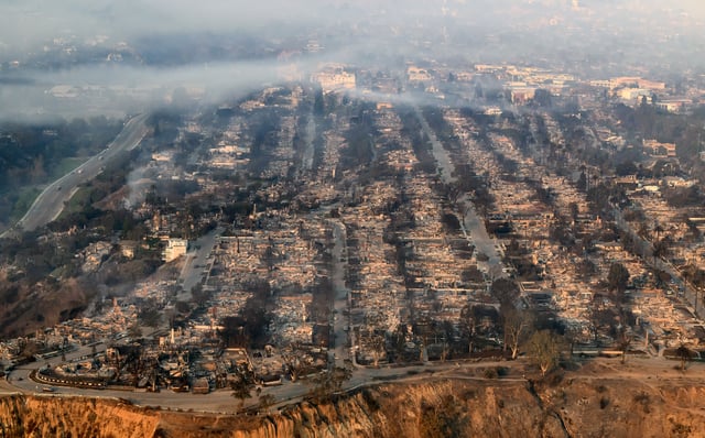 Homes burned from the Palisades fire smolder near the Pacific Palisades neighborhood, on Jan. 9, 2025.