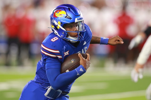 Kansas football quarterback Isaiah Marshall (8) runs the ball during a game against Fresno State at David Booth Kansas Memorial Stadium on Aug. 23, 2025.