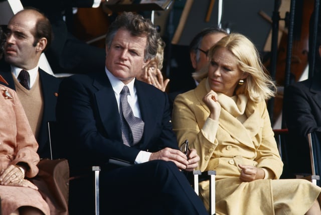 United States Senator Edward Kennedy sits with his wife, Joan, at a John F. Kennedy Library dedication.