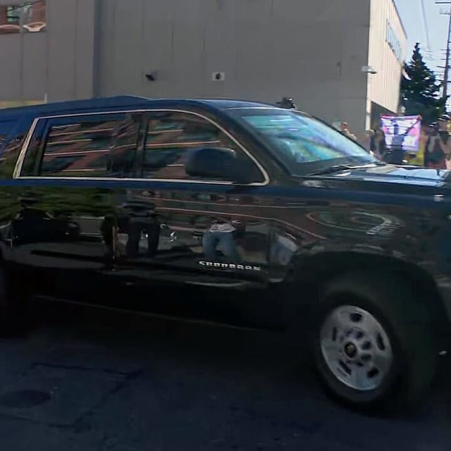 A photographer attempts to photograph U.S. Department of Homeland Security Secretary Kristi Noem as she leaves the ICE facility in Portland, Oregon. It was unknown if she was in this vehicle. During her visit to Portland, Noem met with Oregon Gov. Tina Kotek and toured the ICE facility that has been the center of protests.  (KATU)