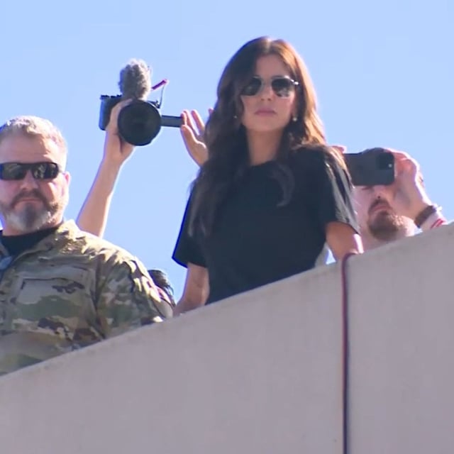 {p}{/p}{p}{/p}U.S. Department of Homeland Security Secretary Kristi Noem looks down from the roof of the ICE facility in Portland, Oregon on Tuesday, Oct. 7, 2025, as conservative influencer, Nick Sortor, right, stands behind her with a cellphone. During her visit to Portland, Noem met with Oregon Gov. Tina Kotek and toured the ICE facility. (KATU)  