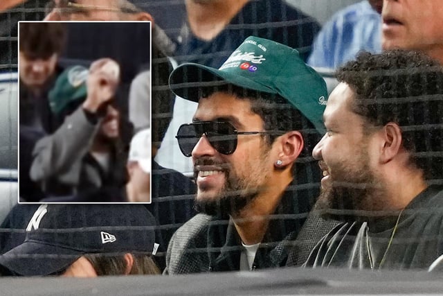 Bad Bunny watches play between the New York Yankees and the Toronto Blue Jays during the second inning of Game 3 of baseball's American League Division Series, Tuesday, Oct. 7, 2025, in New York. Bad Bunny came up with a foul ball during the game (inset). (AP Photo/Yuki Iwamura)