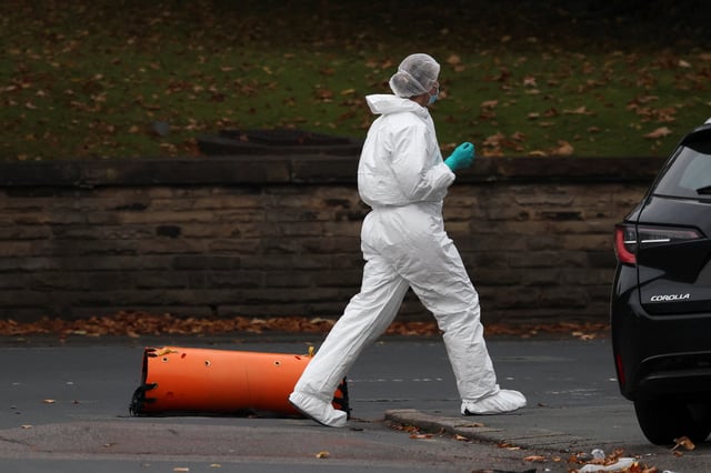 A forensic technician works at the scene after a man drove a car into pedestrians and stabbed a security guard in an attack at a synagogue where worshippers were marking Yom Kippur, the holiest day on the Jewish calendar, according to the British police, in north Manchester, Britain, October 2, 2025. REUTERS/Phil Noble