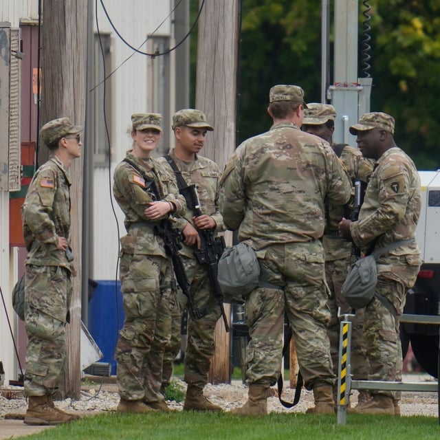 Military personnel in uniform, with the Texas National Guard patch on, are seen at the U.S. Army Reserve Center, Tuesday, Oct. 7, 2025, in Elwood, Ill., a suburb of Chicago. (AP Photo/Erin Hooley)