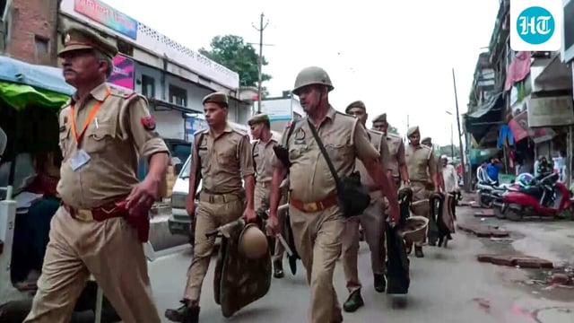 FILE PHOTO: Police personnel conduct a flag march in Kanpur. (ANI Video Grab)