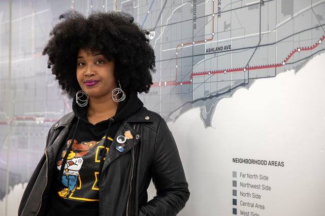 Tonika Lewis Johnson with an exhibit of her Folded Map Project, which compares North and South Side addresses, at Englewood Branded in Chicago on Nov. 6, 2019. (Erin Hooley/Chicago Tribune)