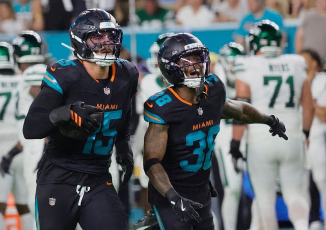 Miami Dolphins linebacker Jaelan Phillips (15) and cornerback Cornell Armstrong celebrate a fumble recovery Monday, Sept. 29, 2025 at Hard Rock Stadium in Miami Gardens. (Joe Cavaretta/South Florida Sun Sentinel)