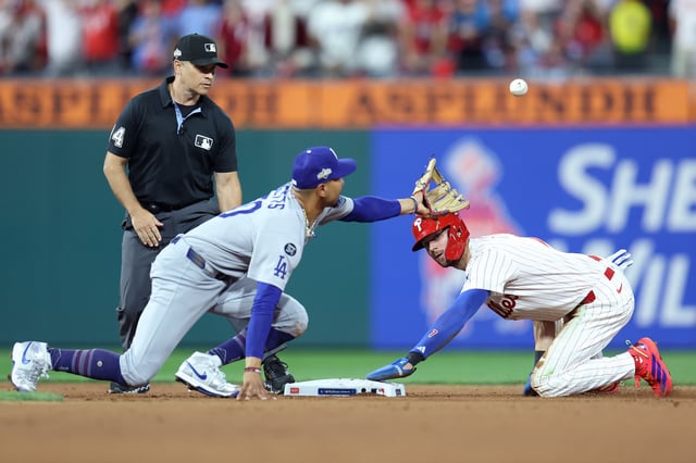 PHILADELPHIA, PENNSYLVANIA - OCTOBER 06: Trea Turner #7 of the Philadelphia Phillies steals second base as Mookie Betts #50 of the Los Angeles Dodgers cannot handle the throw during the sixth inning in game two of the National League Division Series at Citizens Bank Park on October 06, 2025 in Philadelphia, Pennsylvania. (Photo by Emilee Chinn/Getty Images)