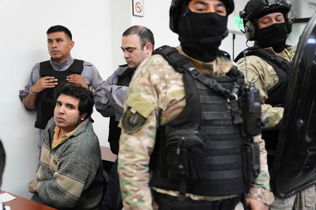 Fernando Sabag Montiel, left, attends the sentencing of those on trial for alleged responsibility for the attempted assassination of former President and Vice President Cristina Fernandez in Buenos Aires, Argentina, Wednesday, Oct. 8, 2025. Montiel, along with Brenda Uliarte and Nicolas Carrizo, is accused of planning and executing the 2022 attack, which Fernandez survived when the gun did not fire. (AP Photo/Rodrigo Abd)