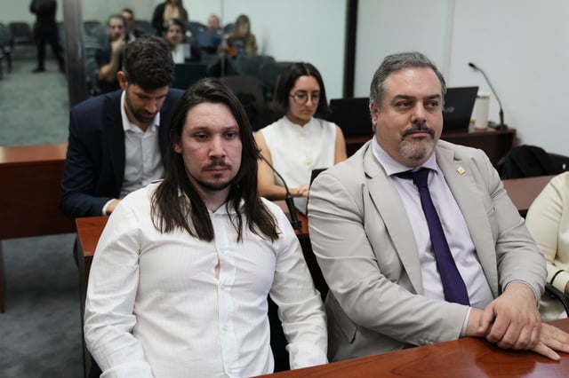 Nicolas Carrizo, left, attends the sentencing of those on trial for alleged responsibility for the attempted assassination of former President and Vice President Cristina Fernández in Buenos Aires, Argentina, Wednesday, Oct. 8, 2025. Carrizo, along with Brenda Uliarte and Fernando Sabag Montiel, is accused of planning and executing the 2022 attack, which Fernandez survived when the gun did not fire. (AP Photo/Rodrigo Abd)