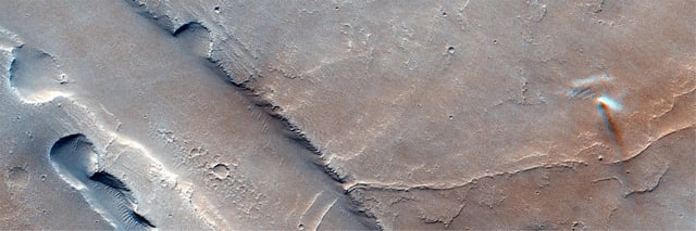 The blurred motion of a dust devil can be seen dancing on Mars on December 3, 2021, through the Colour and Stereo Surface Imaging System on ExoMars Trace Gas Orbiter.