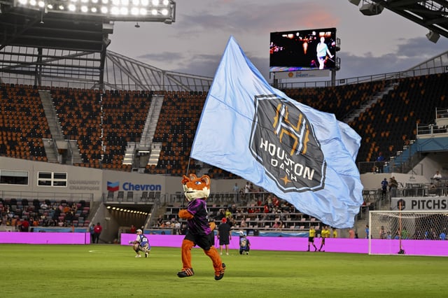 Oct 3, 2025; Houston, Texas, USA; Houston Dash mascot Diesel runs the flag on the pitch prior to the match against the Orlando Pride at Shell Energy Stadium. Mandatory Credit: Maria Lysaker-Imagn Images/ File Photo